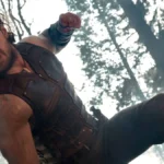 Aaron Taylor-Johnson como "Kraven, o Caçador", em filme homônimo de 2024. O anti-herói está dando socos em alguém, a câmera é vista de baixo para cima.