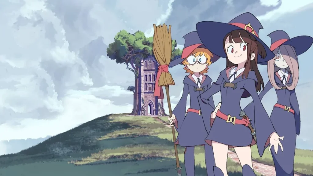 10 Animes na Netflix que Você Não Pode Perder 2 Protagonistas de Little Withc Academia com as roupas da escola de magia e como se posassem para uma foto.