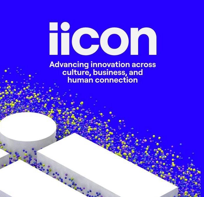 Primeiro poster da IICON, sucessora da E3. Imagem promocional em um tom de azul arroxeado, com pessoas em um pavilhão minimalista branco nesse fundo roxo. É possível ver pessoas representadas por várias cores para dar a ideia de movimento.