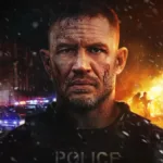 “Um Filme Minecraft” Estreia Quebrando Recordes e Consolida o Sucesso de um Fenômeno dos Games Protagonista do drama de ação "Havoc" (2025), pela Netflix. Cinzas caem pela tela e há um incêndio ao fundo. Ele faz uma cara séria, com um olhar profundo, quase chocado, mas ainda muito sério.