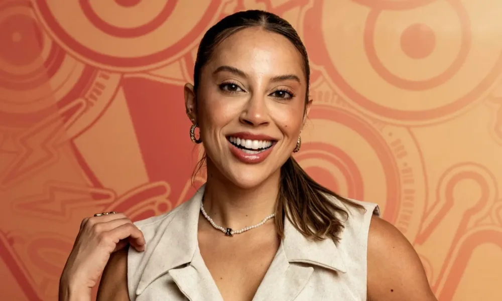 Campeã do BBB 25, Renata Saldanha, em pose para foto com fundo do BBB.