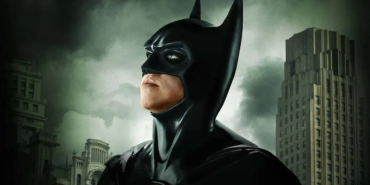 Val Kilmer | A Despedida de um Astro que Marcou Gerações Val Kilmer como o Batman de "Batman para Sempre", olhando para o céu cinza de Gotham.