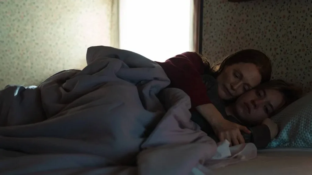 Echo Valley | Tão Confuso Quantos os Conflitos da Mãe Interpretada por Julianne Moore 1 Julianne Moore e Sydney Sweeney são mãe e filha, abraçadas em uma cama, ambas com feição de preocupação, em "Echo Valley".
