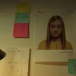 Imagem do filme "A Garota Artificial", com uma parede com informações cheia de informações, post-its, dados, como próprio de investigação.