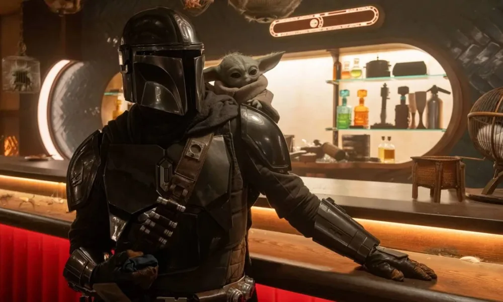 Grogu, o Baby Yoda, à direita, e o Mandaloriano Din Djarin à esquerda no filme "O Mandaloriano e Grogu".