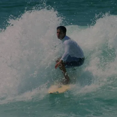 Guido Schäffer surfando no mar. Imagem do site oficial.