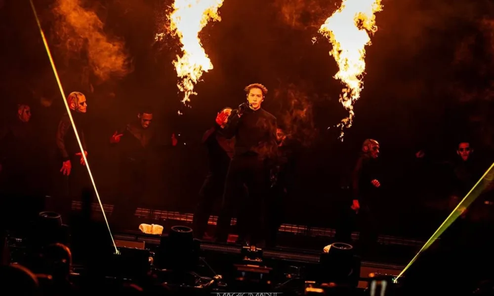 Jackson Wang em apresentação na Magic Man II World Tour, 2026. Cantor está no palco e há efeitos de pirotecnia à sua esquerda e direita.