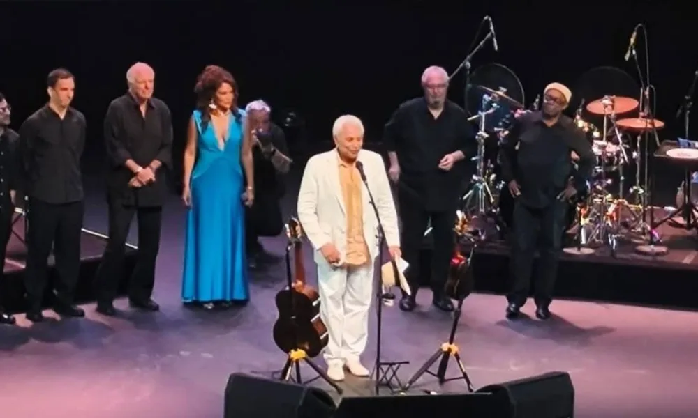 Paulinho da Viola, imagem horizontal, em palco no Qualistage 2026 ao lado de outros artistas..