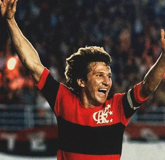 Crop do pôster do filme documentário "Zico: Samurai do Quintino", da Globo Filmes. Jogador está em partida comemorando gol com braços erguidos.