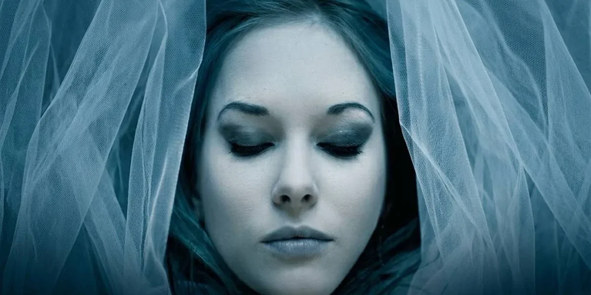 A Garota do Lago | Vale a Pena Ler o Thriller de Charlie Donlea? Imagem horizontal com a capa do livro "A garota do lago" em destaque, sem nada escrito. Garota com pele pálida, filtro azul, coberta por um véu, de maquiagem azul/cinza e olhos fechados.