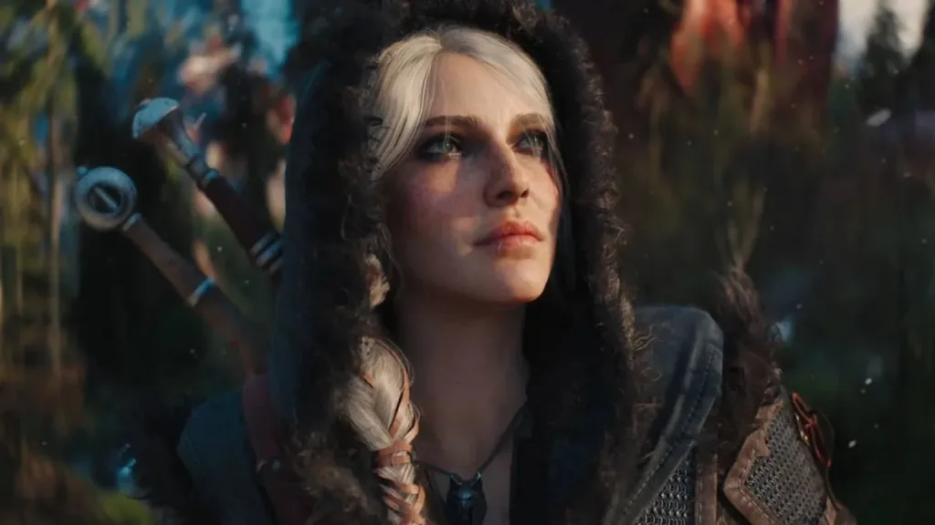 Ciri de The Witcher em cena nos jogos olhando levemente ao alto, câmera focada em seu rosto, vestida com roupas de frio.
