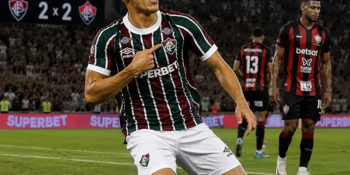 Kevin Serna, de joelhos comemorando, apontando para o escudo do time, em partida contra o Vitória, empatando em 2x2. Imagem gerada por IA.