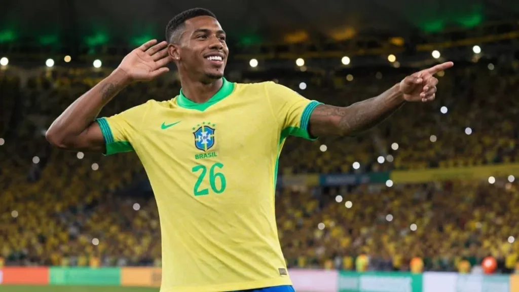 Brasil Goleia o Panamá em Amistoso de Despedida no Maracanã 1 Rayan, braço esquerdo estendido, mão esquerda à orelha, comemora em partida com camisa da seleção. Imagem gerada por IA.