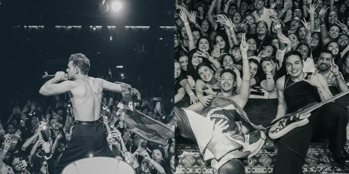 Após Anos Longe dos Palcos Brasileiros, Ruggero Retorna ao País e Esgota Dois Shows em São Paulo Colagem com duas fotos postadas pelo cantor italiano Ruggero de show seu em São Paulo dia 29 de maio de 2026. Na primeira sem camisa, de costas, na segunda deitado no palco, coberto com uma bandeira do Brasil, sorrindo e posando com a plateia ao lado do guitarrista, posando para foto. Foto em PB.
