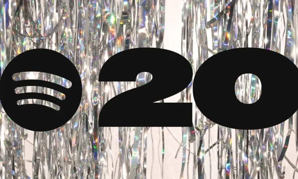 Logo do Spotify e o número 20, representando seus 20 anos, em fundo espelhado.